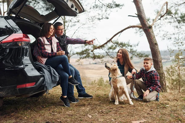 Happy Family Sitting Having Fun Dog Modern Car Outdoors Forest — Photo
