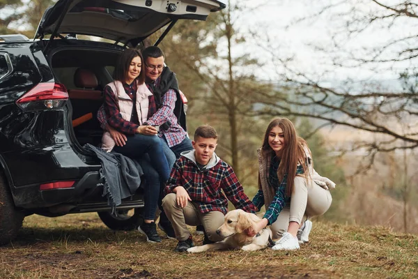 Happy Family Sitting Having Fun Dog Modern Car Outdoors Forest — Photo