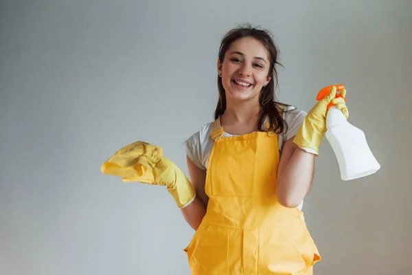 Housewife Yellow Uniform Standing Cleaning Spray Windows Indoors House Renovation — Zdjęcie stockowe