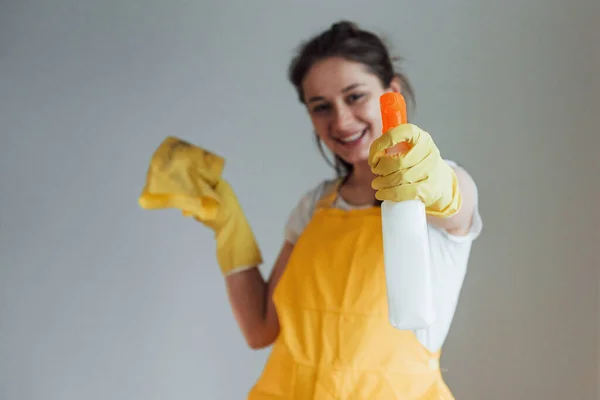 Housewife Yellow Uniform Standing Cleaning Spray Windows Indoors House Renovation — Zdjęcie stockowe