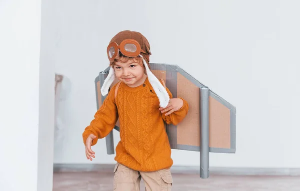 Little Boy Retro Pilot Uniform Running Toy Plane Indoors — Zdjęcie stockowe