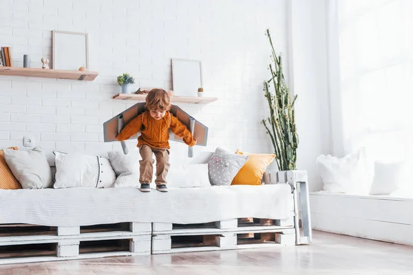 Little Boy Retro Pilot Uniform Running Toy Plane Indoors — ストック写真