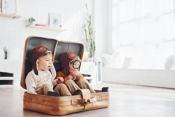 Two Little Boys Have Fun Sitting Suitcase Indoors Daytime — Stok fotoğraf