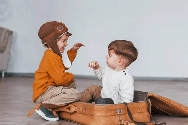 Two Little Boys Have Fun Sitting Suitcase Indoors Daytime — Stok fotoğraf