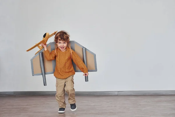 Little Boy Retro Pilot Uniform Running Toy Plane Indoors — Stok fotoğraf