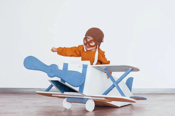 Little Boy Retro Pilot Uniform Having Fun Toy Plane Indoors — Stockfoto