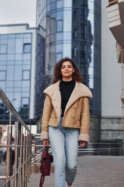 Genç kız şehir dışında iş binasının yakınında yürüyüşe çıktı..