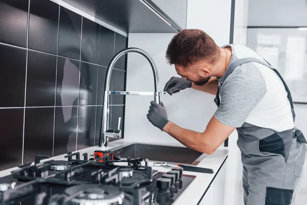 Young Professional Plumber Grey Uniform Fixing Water Tap Kitchen — Zdjęcie stockowe