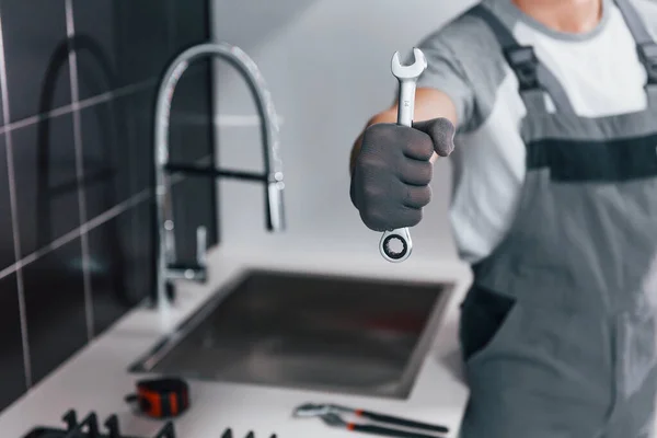 Close View Young Professional Plumber Grey Uniform Holding Wrench Hand — Zdjęcie stockowe