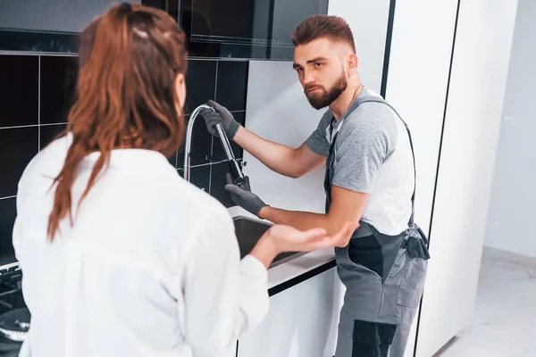 Young Professional Plumber Grey Uniform Shows Results Work Housewife Kitchen — Stockfoto