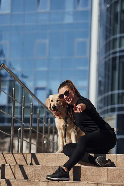 Young Positive Woman Sitting Stairs Her Dog Have Walk Outdoors — Stockfoto