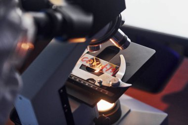 Close up view of scientist in protective uniform that works with coronavirus in laboratory.