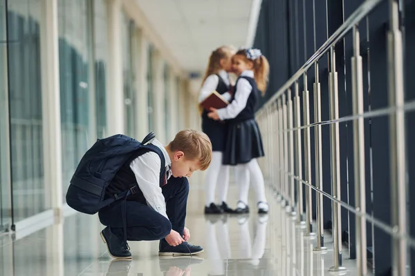 Boy Sitting Floor School Kids Uniform Together Corridor — стоковое фото