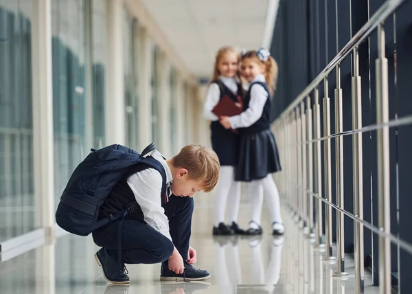 Boy Sitting Floor School Kids Uniform Together Corridor — Zdjęcie stockowe