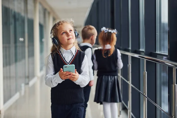 Little Girl Phone Headphones Standing Front School Kids Uniform Together — 图库照片