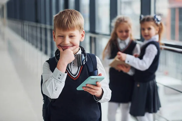 Little Boywith Phone Headphones Standing Front School Kids Uniform Together — Fotografia de Stock