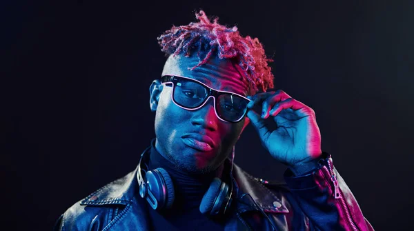 Stylish Glasses Wireless Headphones Futuristic Neon Lighting Young African American — стокове фото