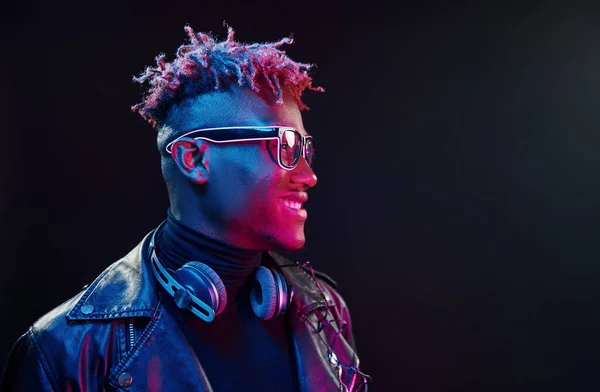 Stylish Glasses Wireless Headphones Futuristic Neon Lighting Young African American — стокове фото