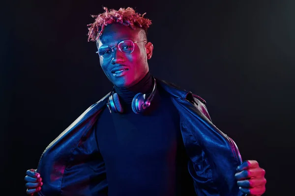 Stylish Glasses Wireless Headphones Futuristic Neon Lighting Young African American — стокове фото