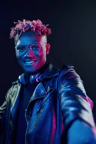 Posing Wireless Headphones Neck Futuristic Neon Lighting Young African American — стокове фото