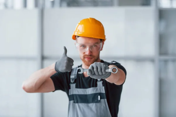 Man Grey Uniform Wrench Hand Standing Indoors Modern Big Office — 스톡 사진