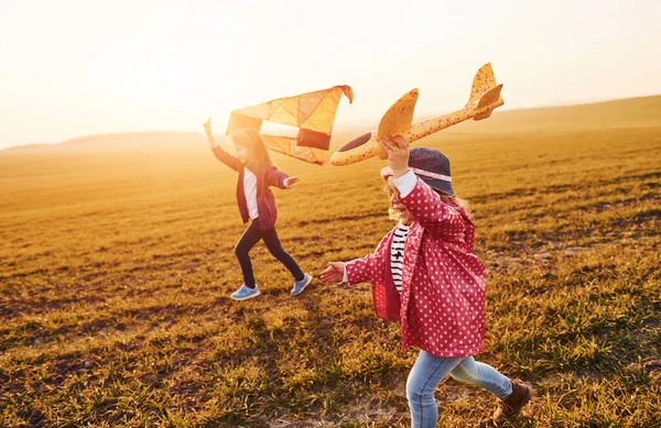 Two Little Girls Friends Have Fun Together Kite Toy Plane — Stockfoto