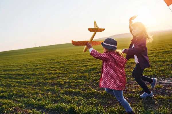 Two Little Girls Friends Have Fun Together Kite Toy Plane — Stock Photo, Image