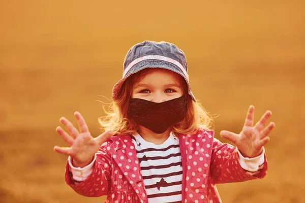 Portrait Cute Little Girl Black Protective Mask Standing Outdoors Illuminated — Stock Photo, Image