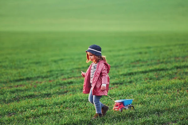 Cute Little Girl Walks Toy Car Beautiful Field Sunny Daytime — Stock Fotó