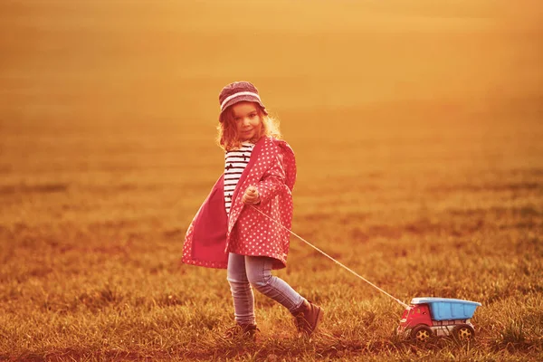 Cute Little Girl Walks Toy Car Beautiful Field Sunny Daytime — Fotografia de Stock