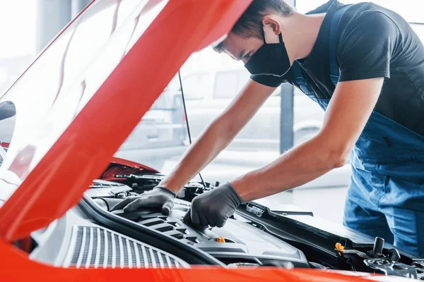 Muž Uniformě Černé Ochranné Masce Pracuje Rozbitým Automobilem Koncepce Autoservis — Stock fotografie