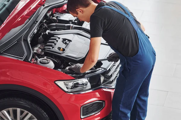 Top View Male Worker Uniform Repairs Red Automobile — Stock Photo, Image