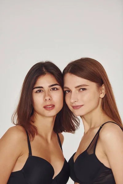 Duas Jovens Mulheres Lingerie Juntas Dentro Casa Fundo Branco — Fotografia de Stock