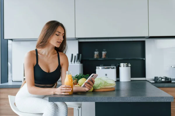 Uses Smartphone Young European Woman Indoors Kitchen Indoors Healthy Food — стокове фото