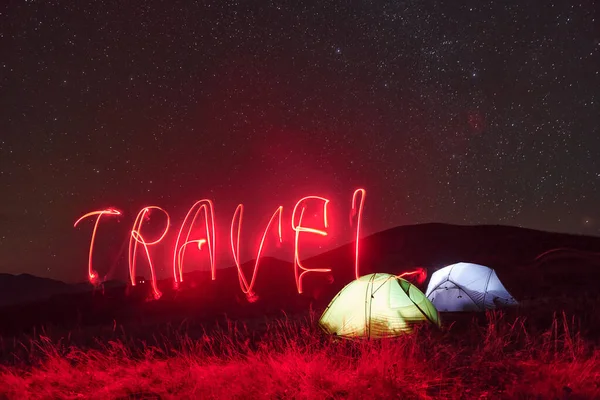 Red Neon Travel Word Two Iluminated Tents Stars Mountains Night — Zdjęcie stockowe