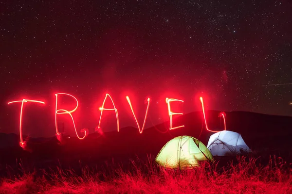 Red Neon Travel Word Two Iluminated Tents Stars Mountains Night — Stock Fotó