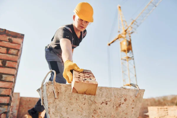 Holding Brick Using Hammer Construction Worker Uniform Safety Equipment Have — Foto de Stock