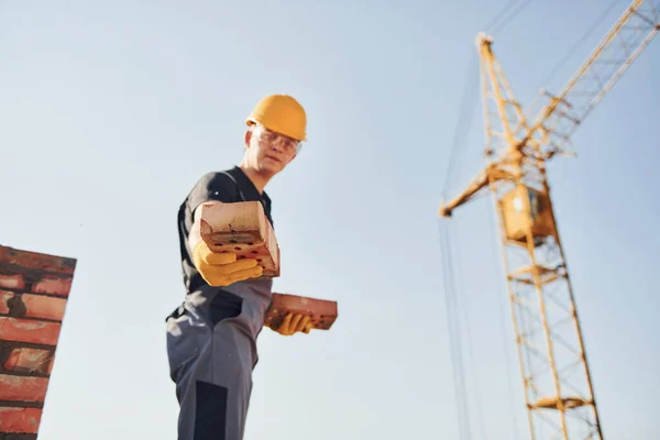 Holds Bricks Hands Construction Worker Uniform Safety Equipment Have Job — Stock Fotó