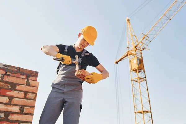 Holding Brick Using Hammer Construction Worker Uniform Safety Equipment Have — Fotografia de Stock