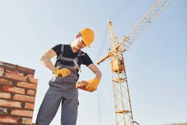 Holding Brick Using Hammer Construction Worker Uniform Safety Equipment Have — Stock fotografie