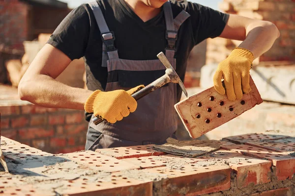 Holding Brick Using Hammer Construction Worker Uniform Safety Equipment Have —  Fotos de Stock