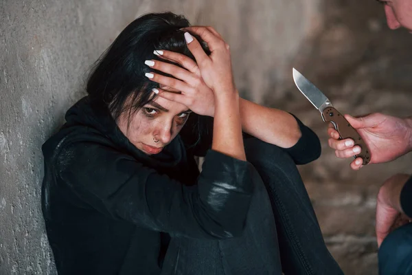 Kidnapped Woman Sitting Threatened Man Knife Hands Abandoned Building — Stock Photo, Image