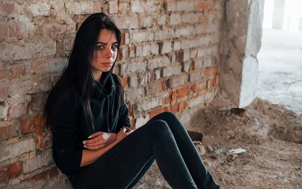 Young Beaten Woman Black Clothes Sitting Floor Abandoned Building — Stok fotoğraf