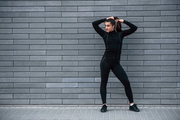 Young Sportive Girl Black Sportswear Standing Outdoors Gray Wall — Foto de Stock
