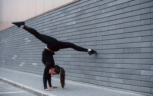 Young Sportive Girl Black Sportswear Doing Hard Handstand Exercises Outdoors — Stok fotoğraf