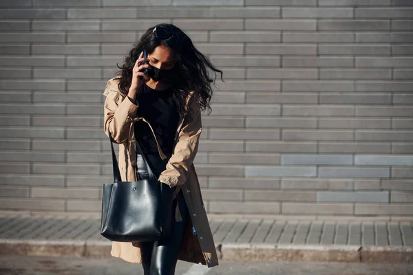 Protective Mask Beautiful Brunette Curly Hair Black Clothes Talking Phone — Stockfoto