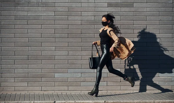 Protective Mask Beautiful Brunette Curly Hair Black Clothes Running Outdoors — Stock Photo, Image