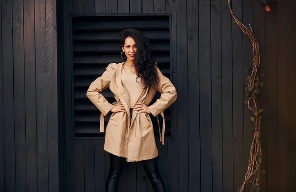 Woman Black Curly Hair Standing Black Wooden Building Exterior — Φωτογραφία Αρχείου