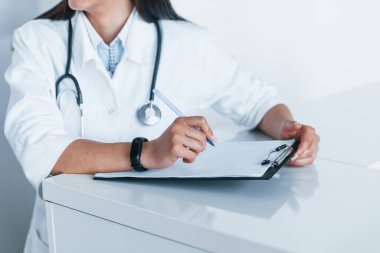 Not defteriyle. Modern klinikteki genç hemşire. Sağlık hizmetleri kavramı.