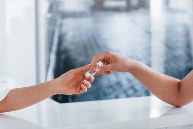 Doktor hastaya ilaç veriyor. Genç bayan, modern klinikteki kadın doktoru ziyaret ediyor..